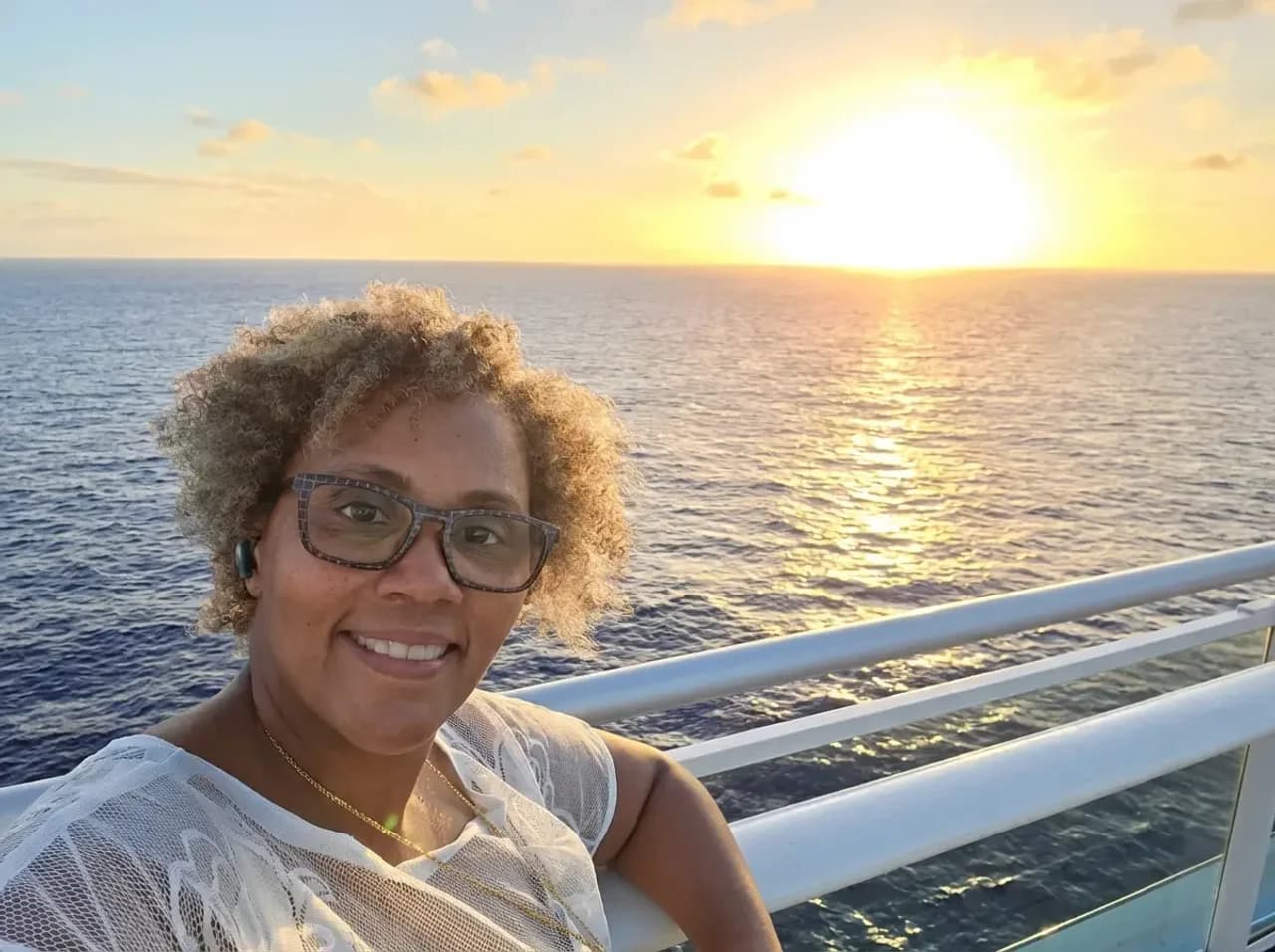Yolanda on the deck of a cruise ship at sunset